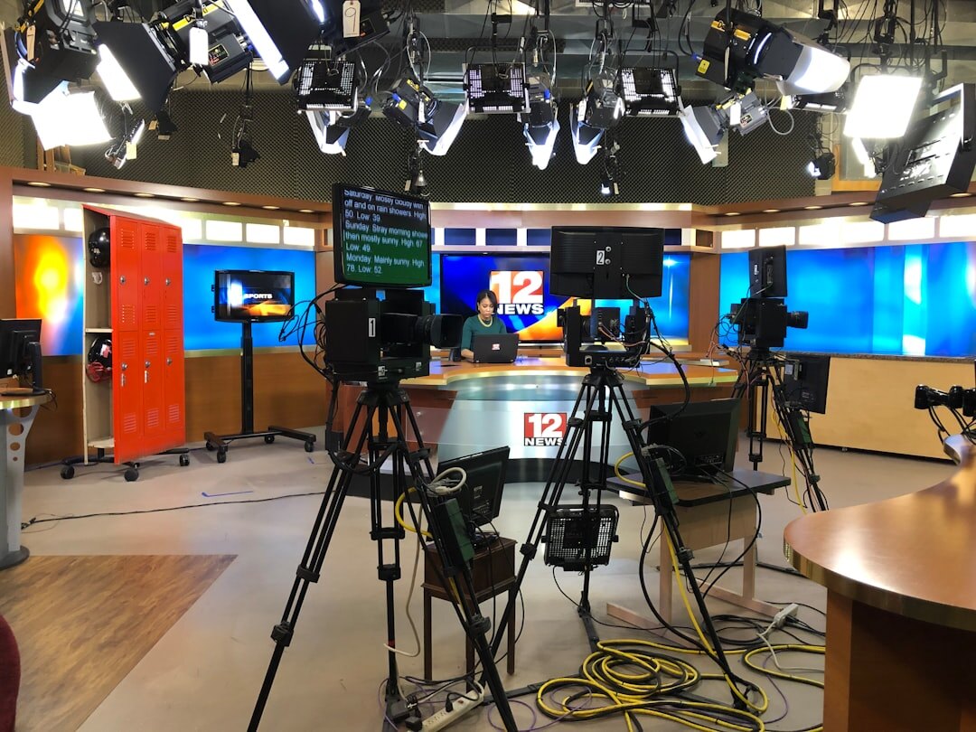 Television news studio with professional lighting and camera equipment