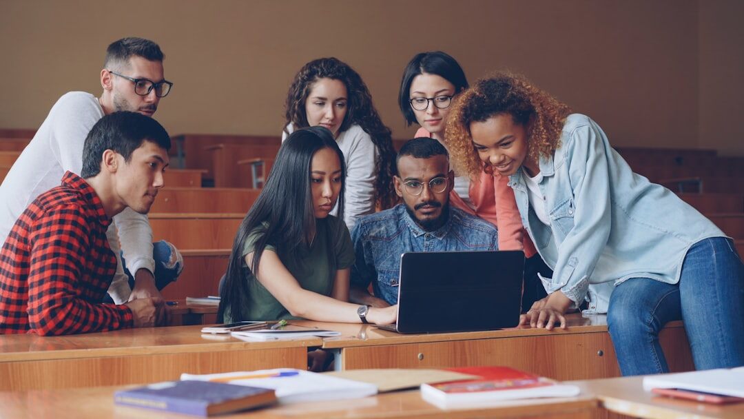 Diverse group of media students working together in a classroom